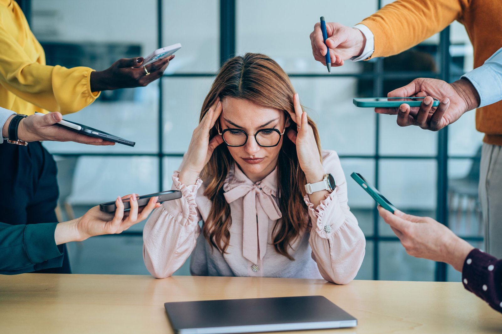 Person feeling overwhelmed in a busy environment